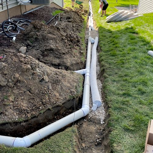 Two gutters and sump exiting near the backyard pro