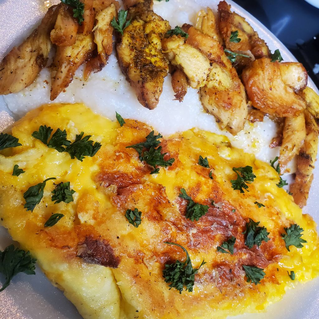 Chicken over grits paired w/ a smothered omlette 