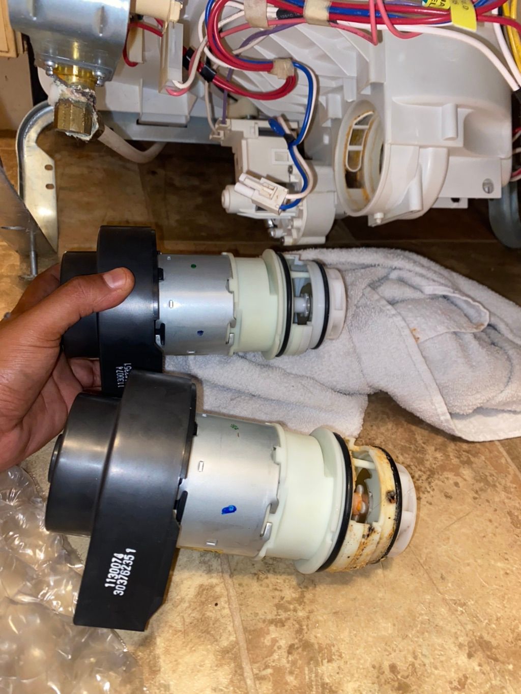 Swapping out a bad motor on a dishwasher. 