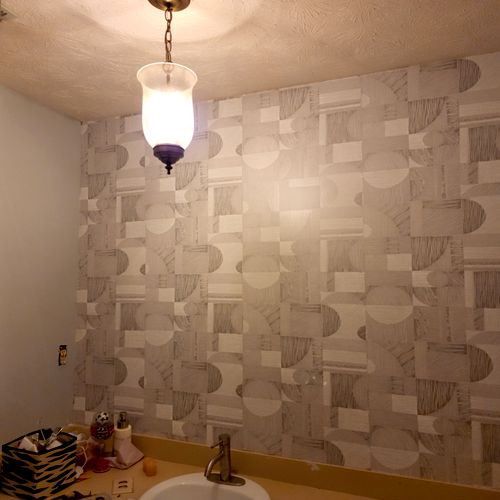 same room, one wall covered in wallpaper. all othe