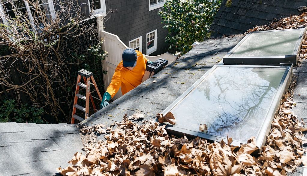 inspecting rain gutters before cleaning