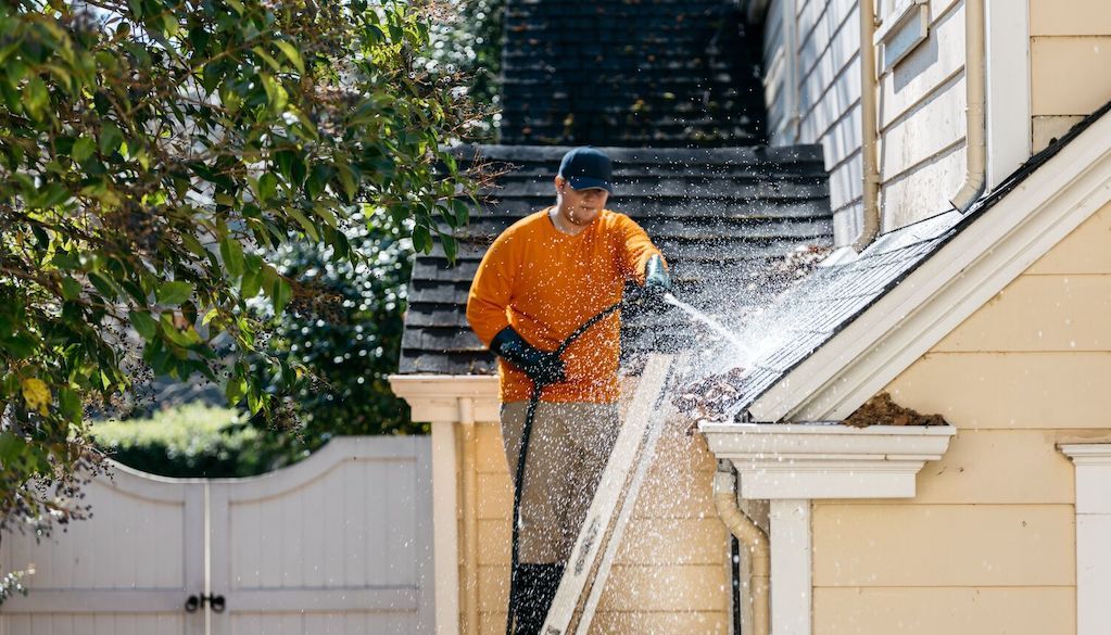 cleaning gutters with pressure washer