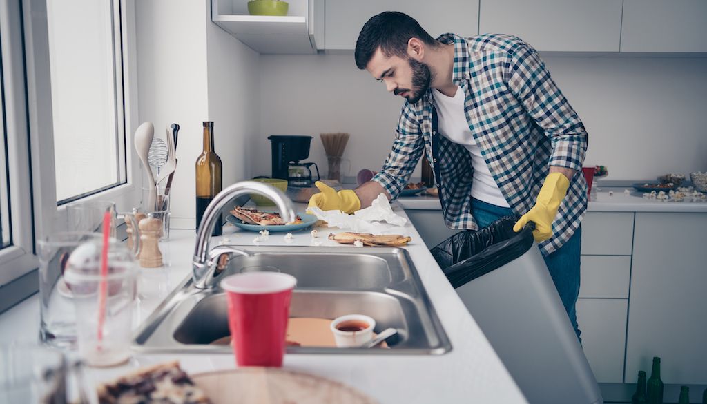 man cleaning kitchen