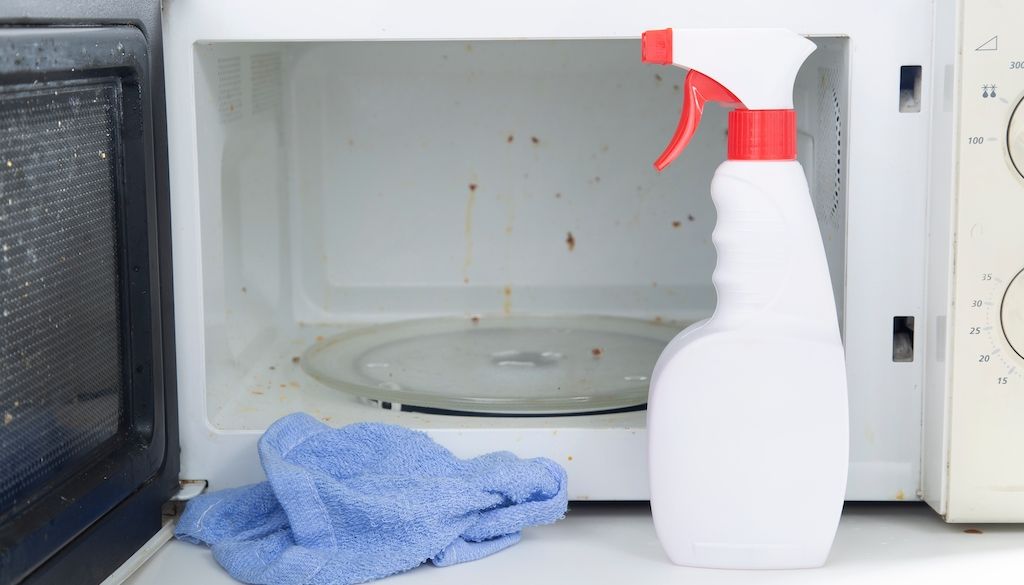 dirty microwave and cleaning supplies