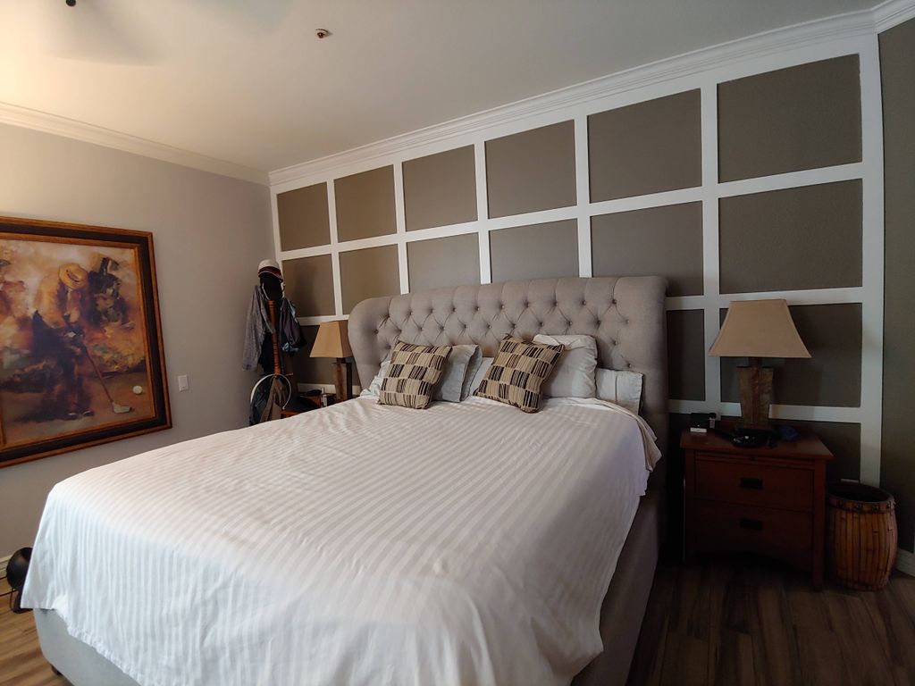 Grid design on the wall makes this bedroom feel li