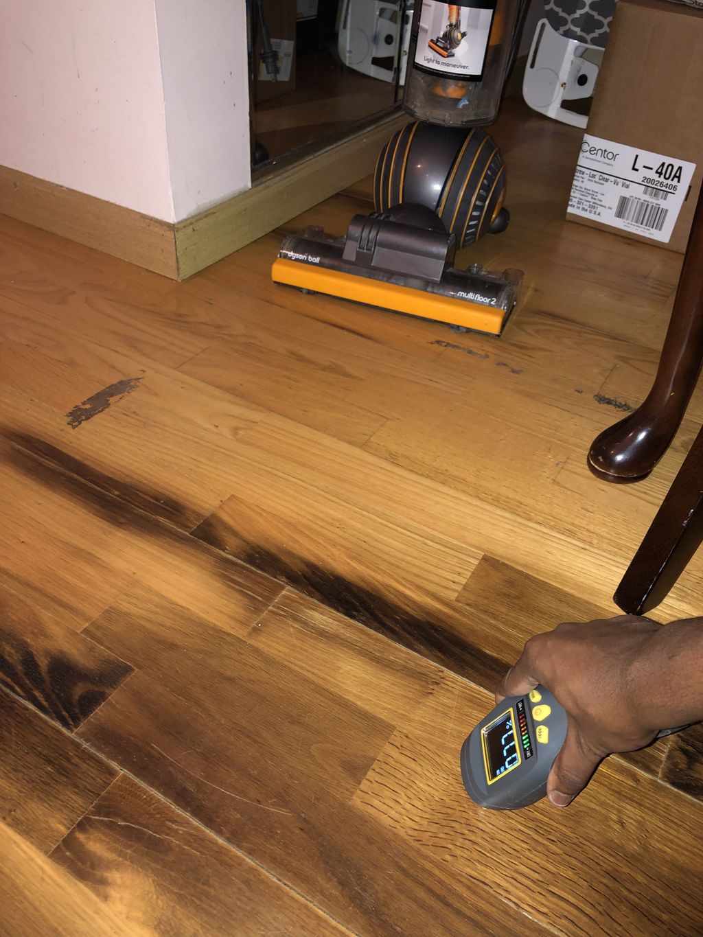 Discolored hardwood flooring due to kitchen leak 