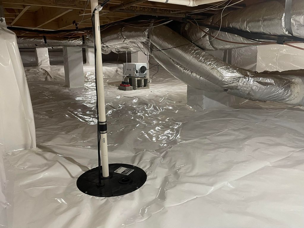 A finished crawl space with a sump pump