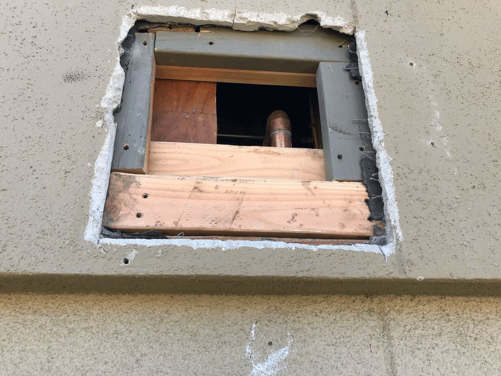 stucco repair job after plumbing pipe repair