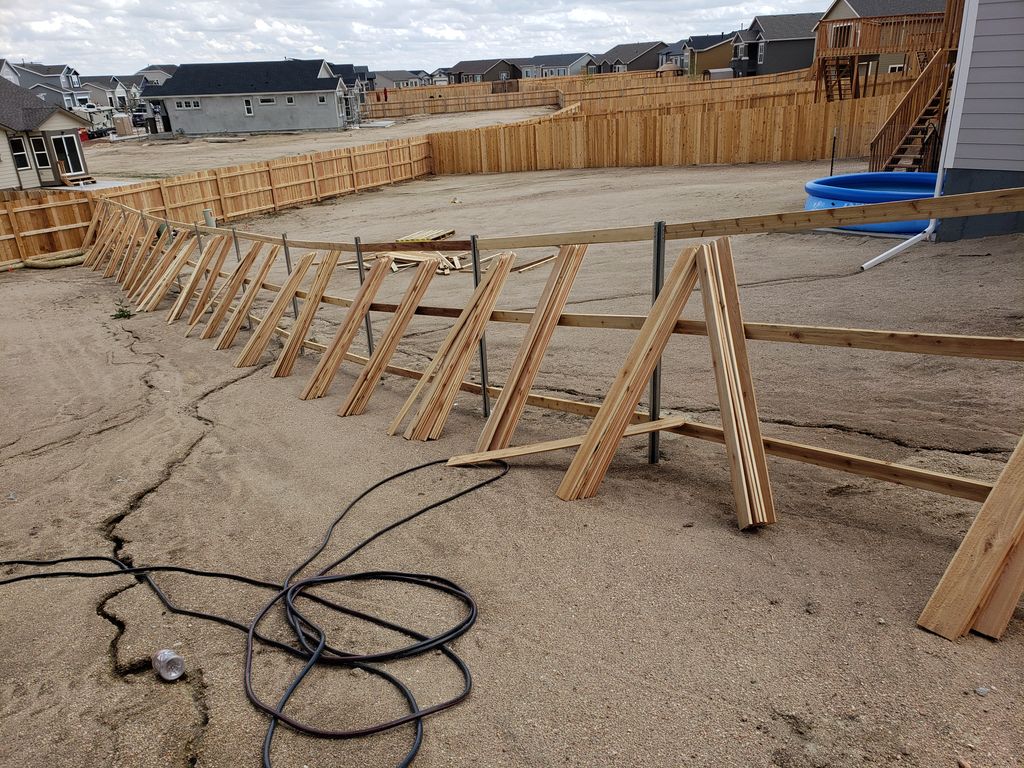 Wrapping up a.steel post privacy fence job