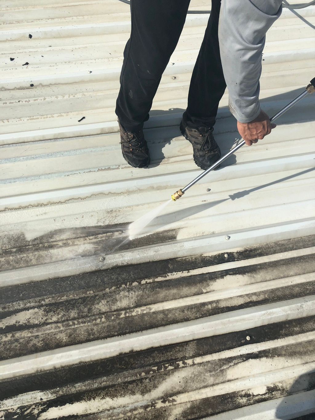 Prepping a metal roof before the application of an