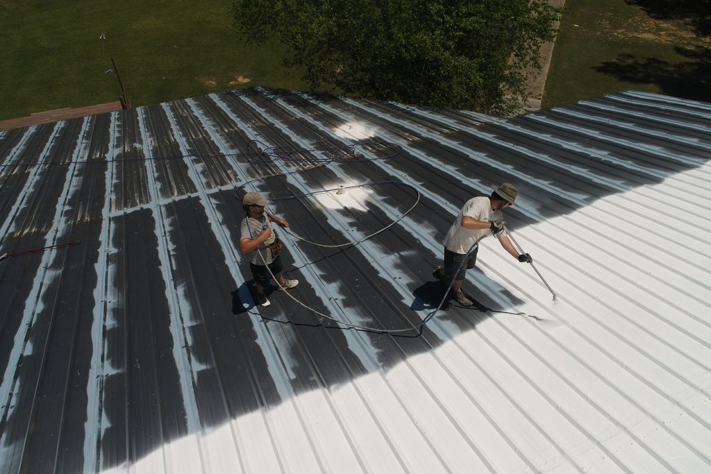 An Elastomeric roof coating being applied to a met