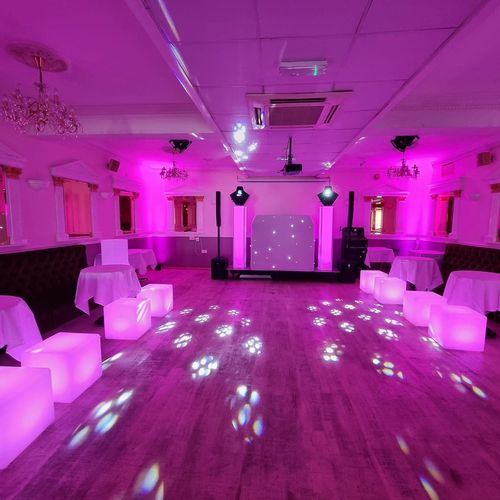 Sweet 16 party setup w/ pink lighting 