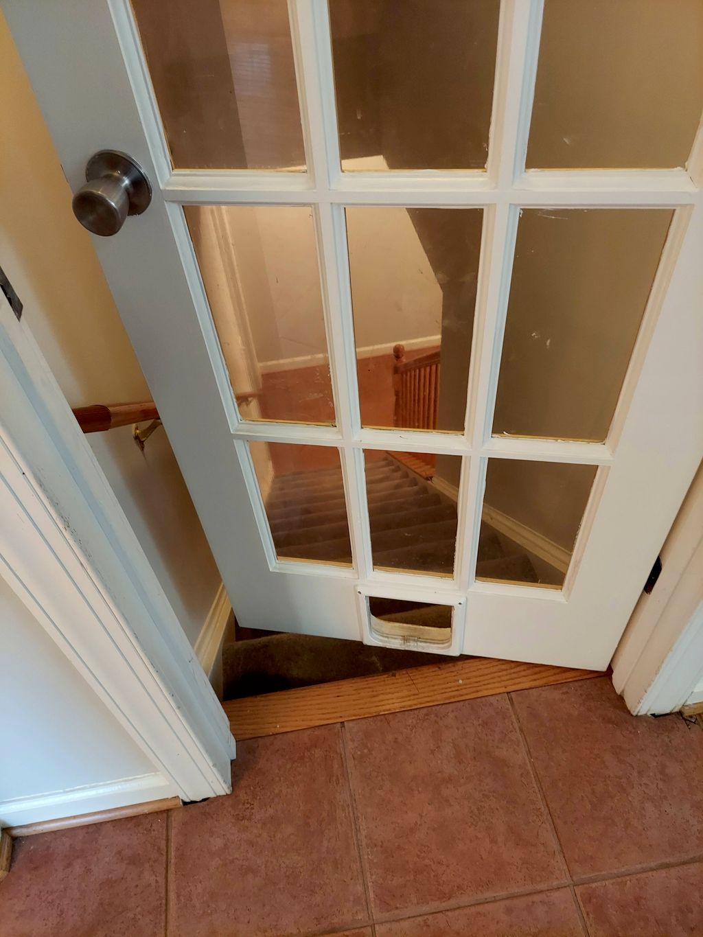 door swings over steps to basement