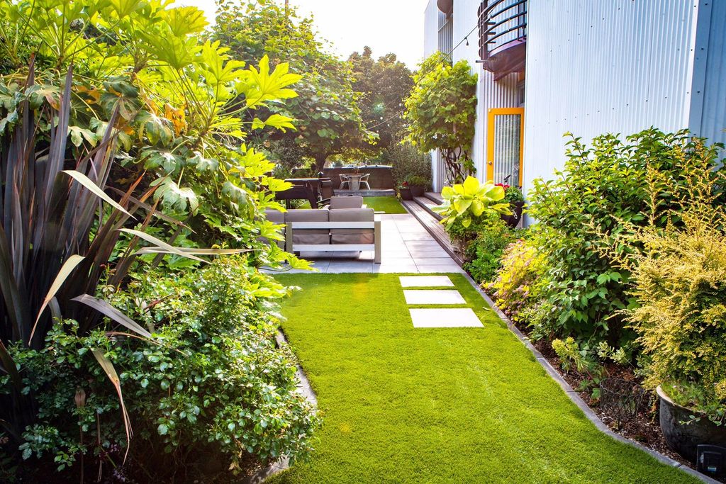 Backyard remodel featuring large paver stones and 