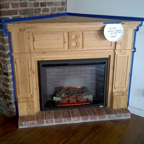 False fireplace with hearth and mantle