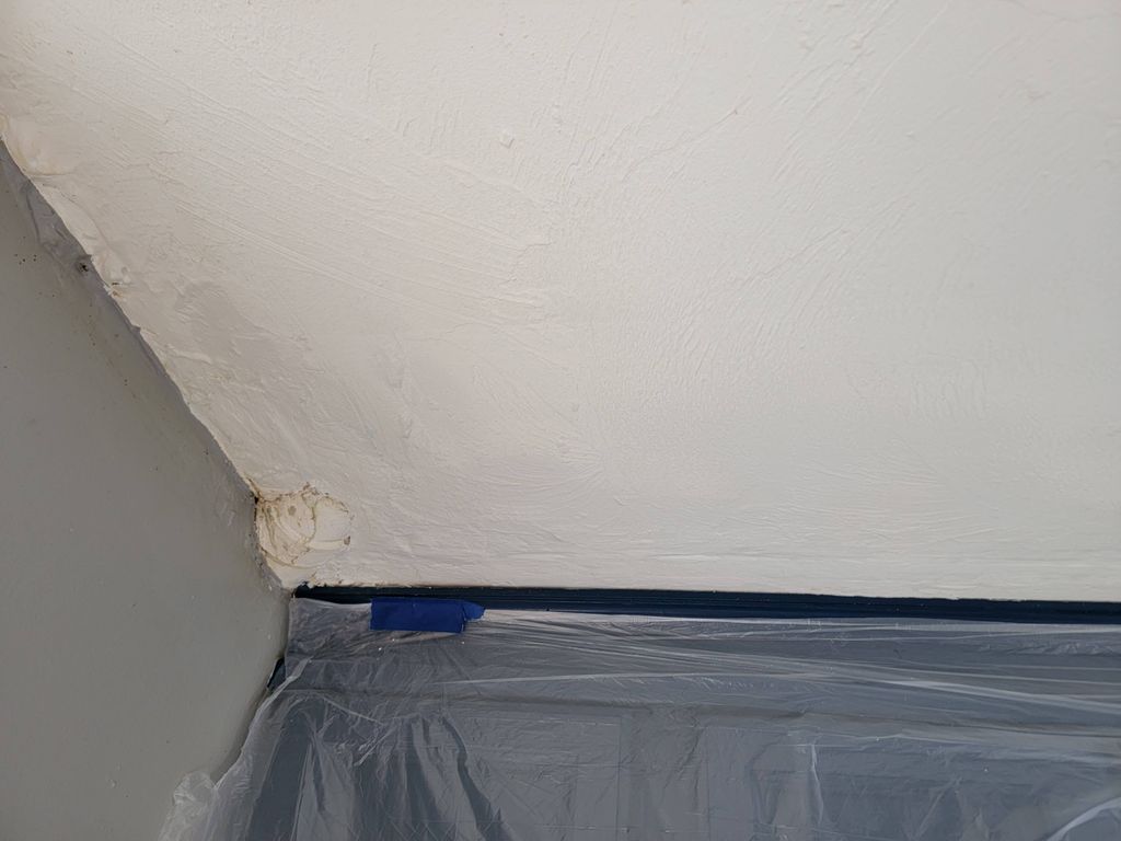 Patched hole in ceiling from water damage