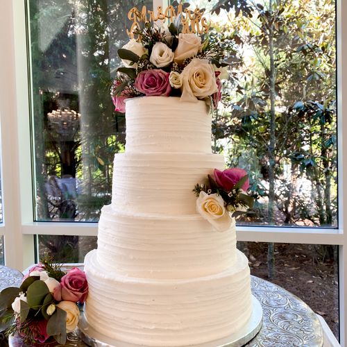 Four tiered buttercream Cake with fresh flowers by