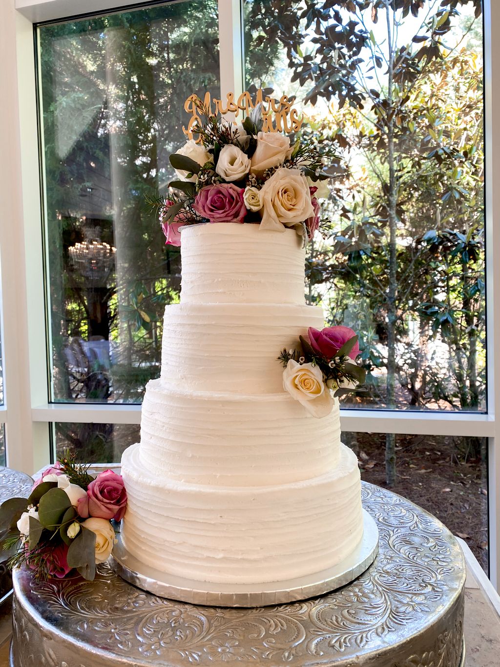 Four tiered buttercream Cake with fresh flowers by