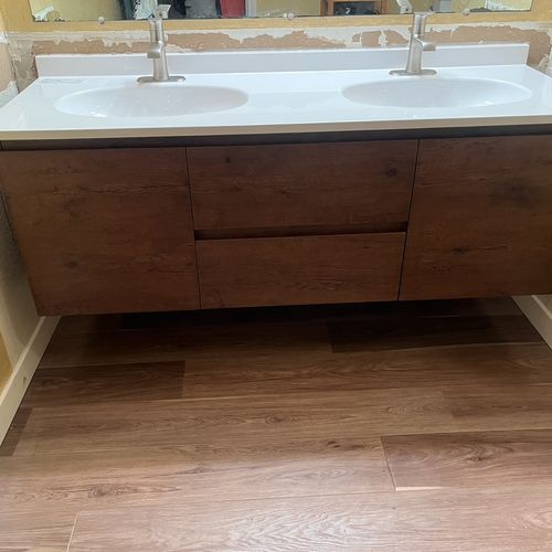 Floating vanity install with double sinks. 
