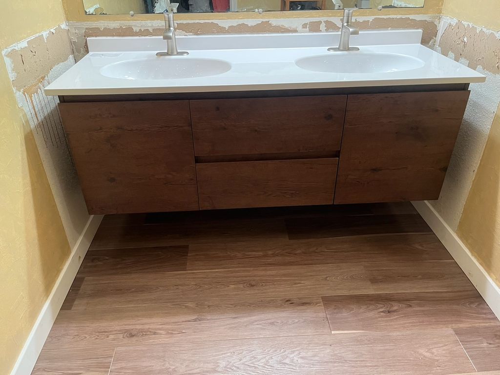 Floating vanity install with double sinks. 