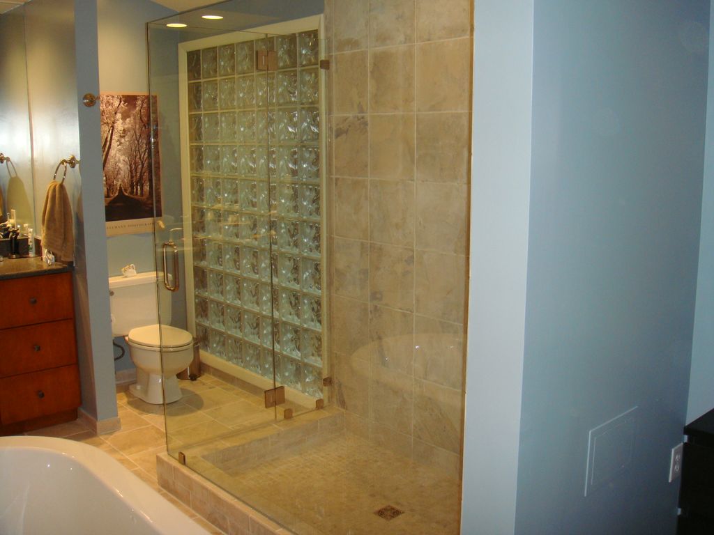 Glass block and large shower next to soaking tub -
