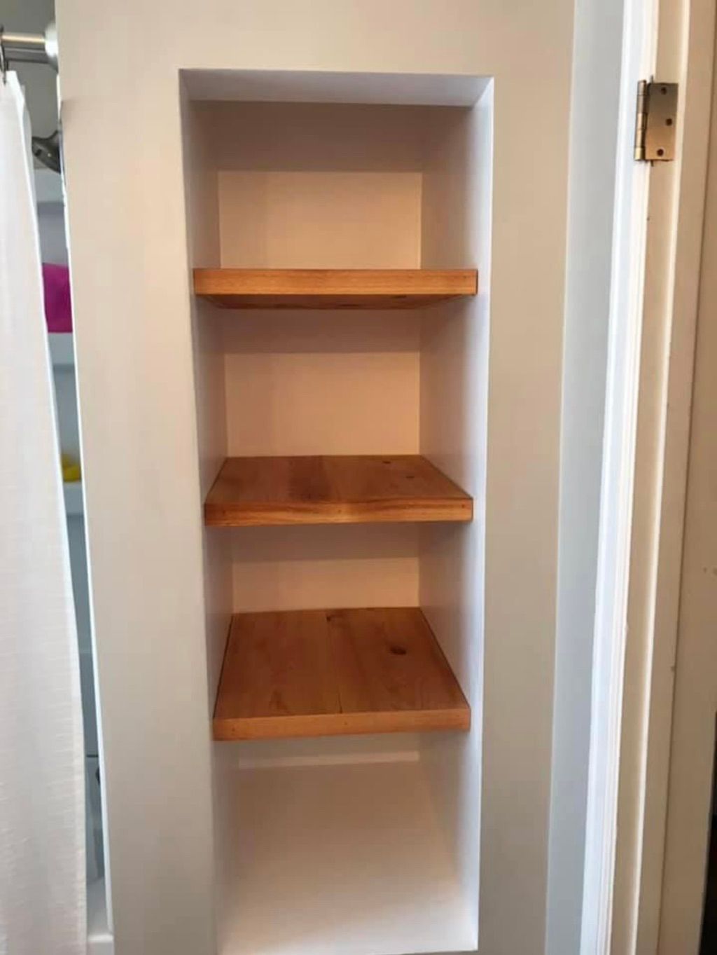 Custom bathroom closet with floating cedar shelves