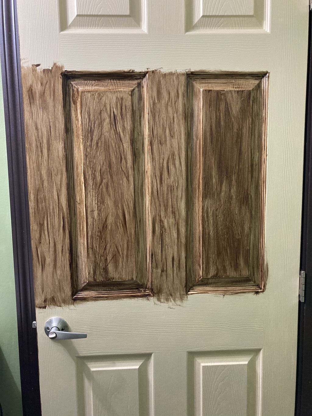 A white metal door made to look like wood