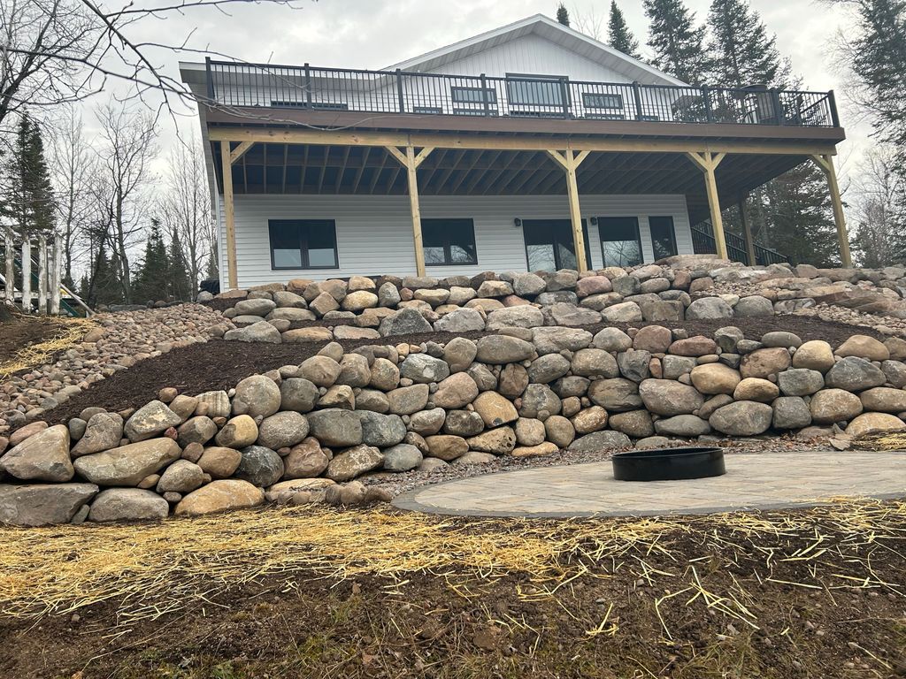 Boulder retaining walls. Firepit patio