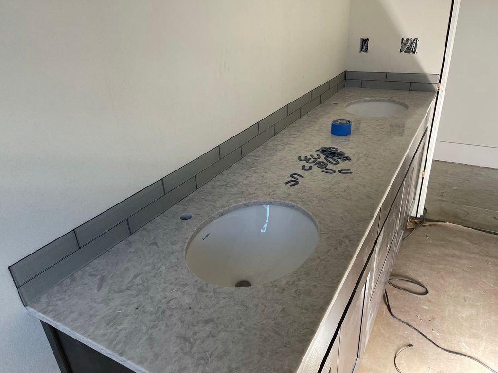 Counter, vanity, and backsplash install. 