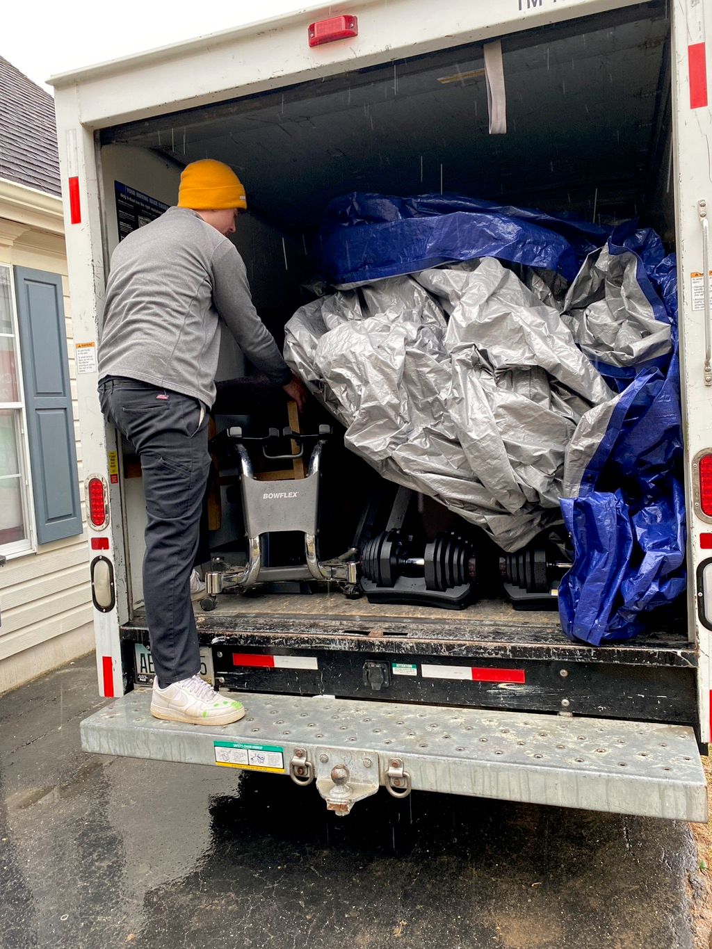 Removing tarp covering to unload truck 