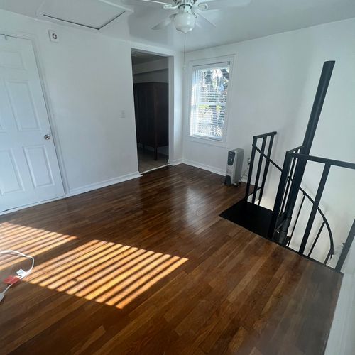 A small bedroom with staircase