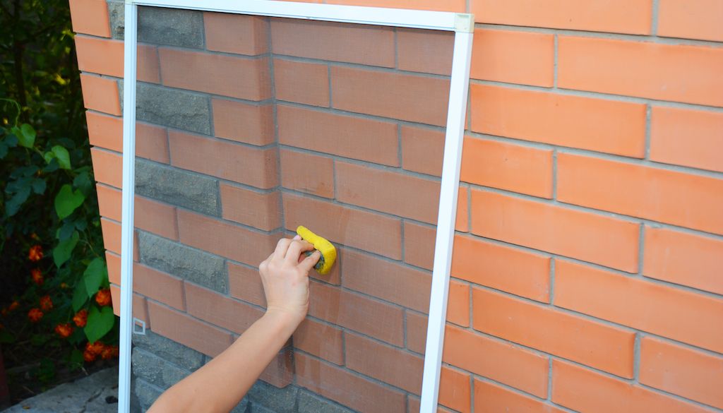 washing window screens with sponge