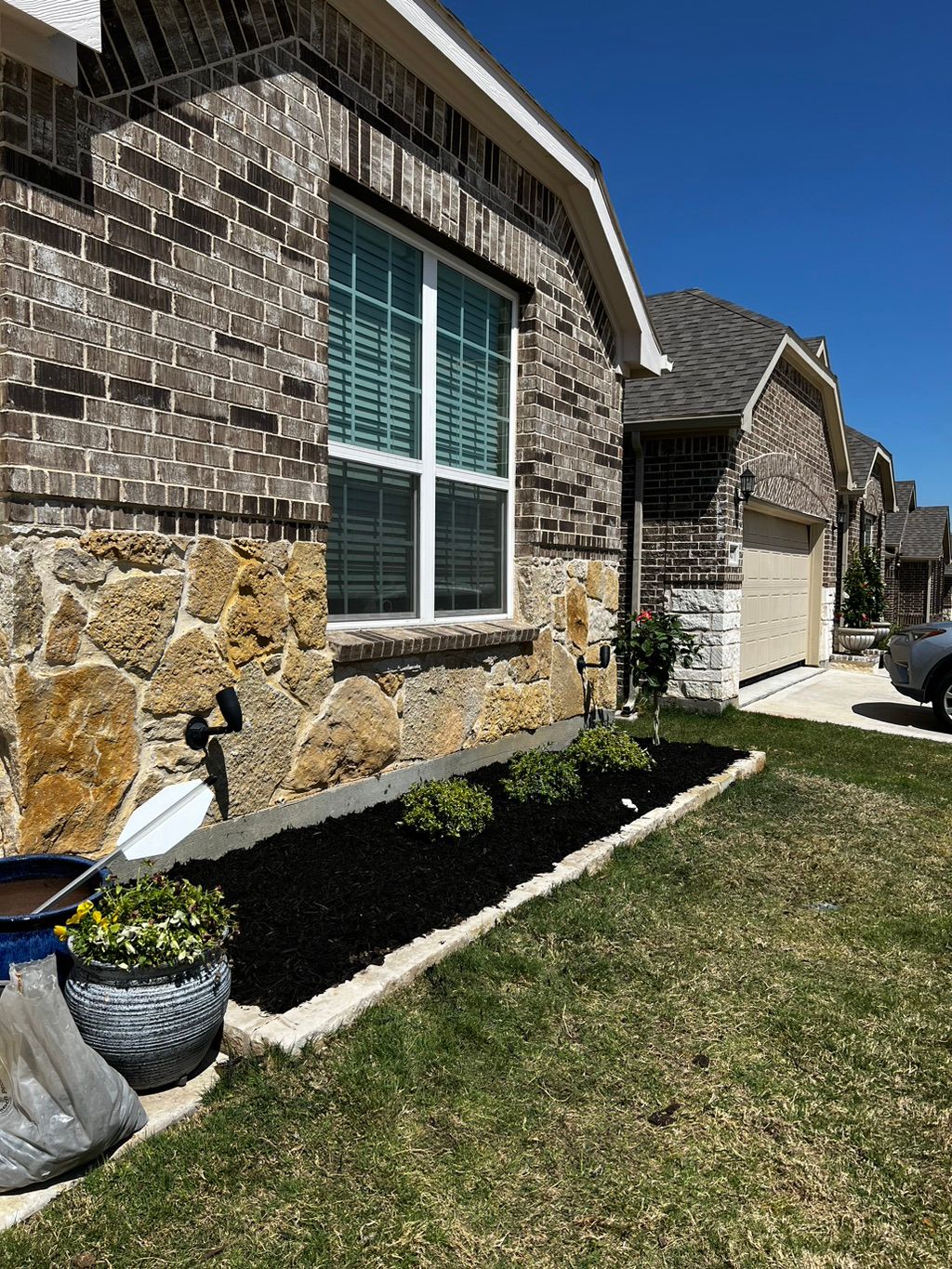 Completed flowerbed makeover. New mulch and shrubs