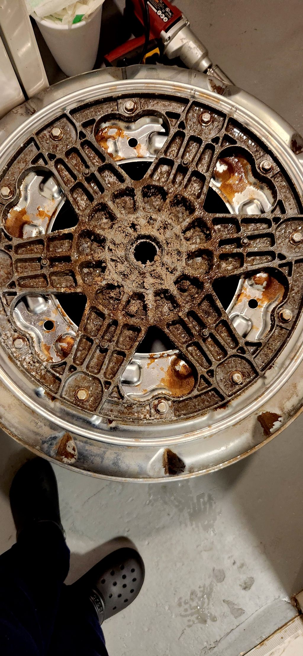 The button of the dryer drum before cleaning
