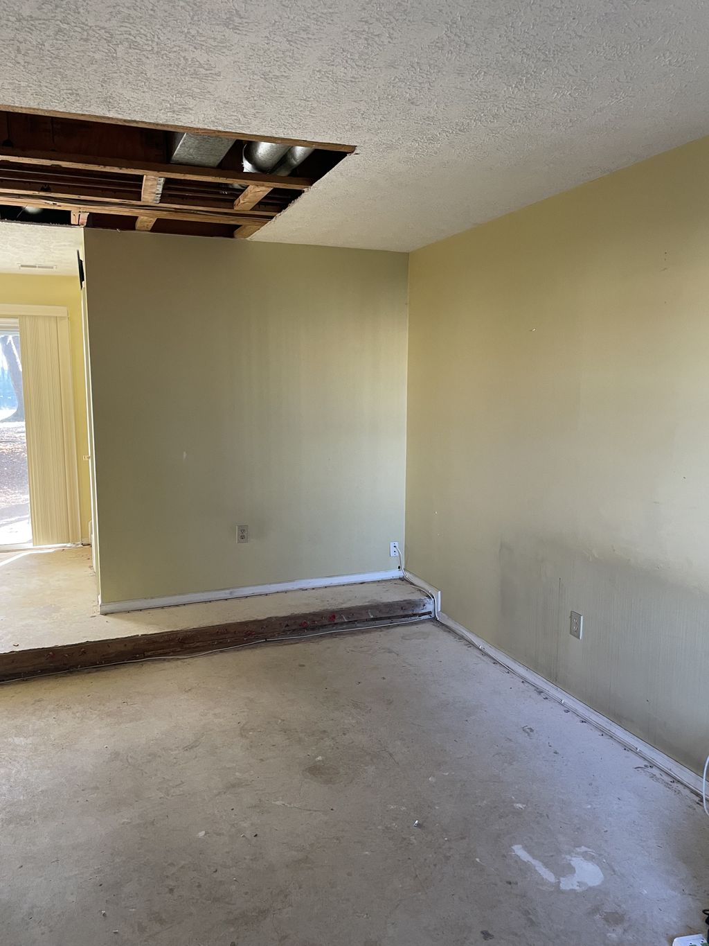 Damaged walls and floor removal job: Before