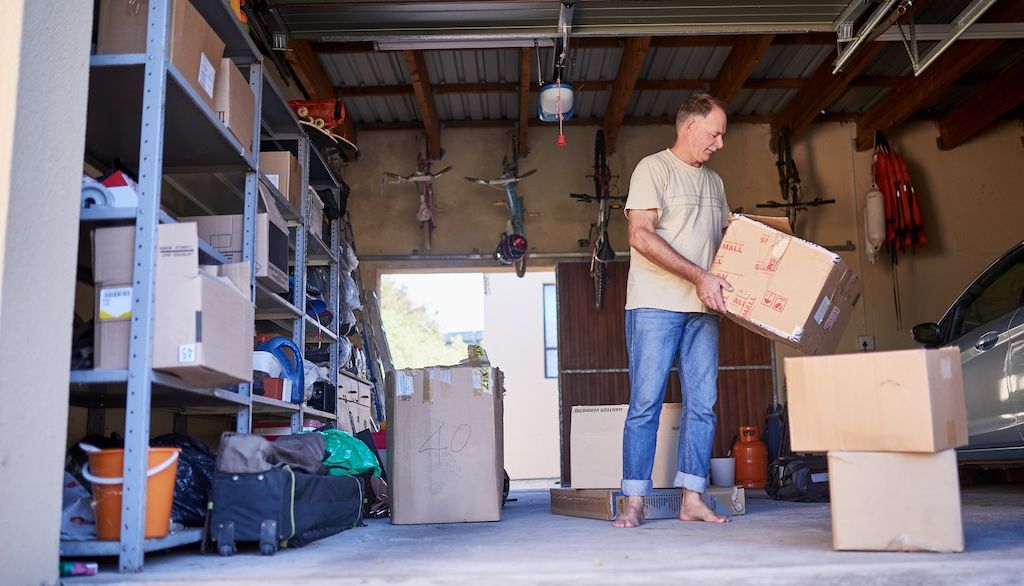 man stocking boxes in garage