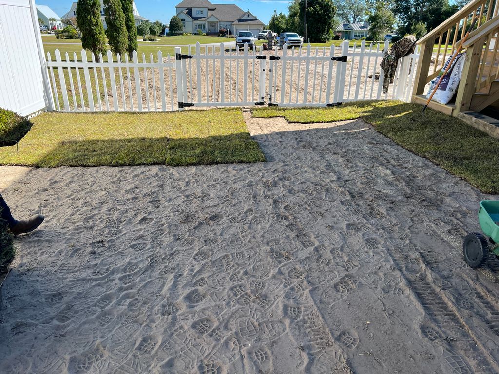 Installing new sod to a yard.