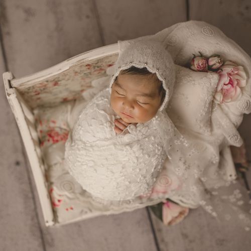 Newborn photo session with bed prop