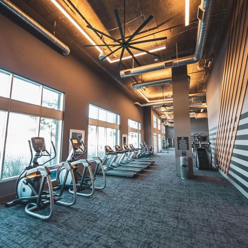 Open gym space, machines, cardio equipment, dumbbe