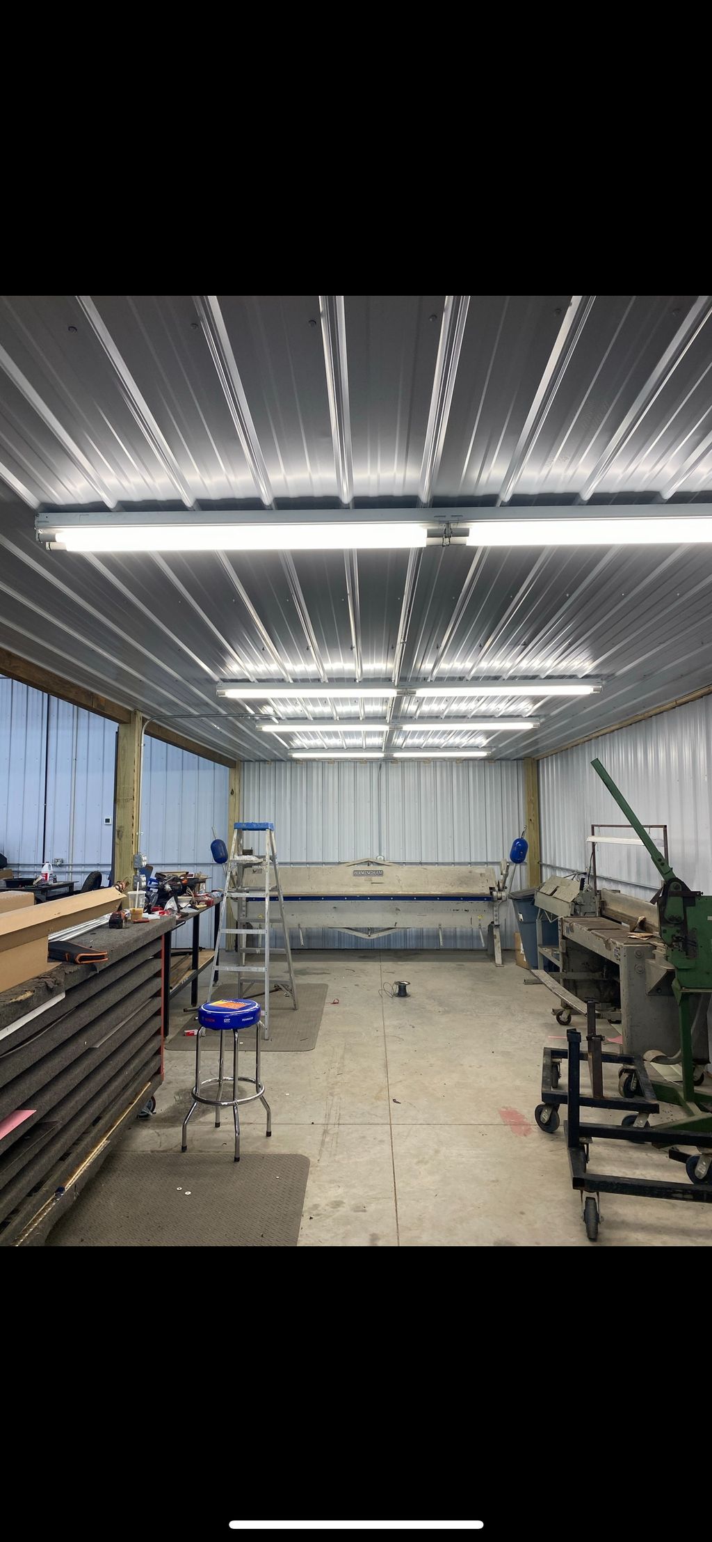 Conduit ran and lights installed in a shop 