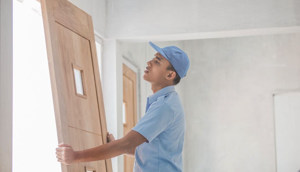 professional installing a slab door