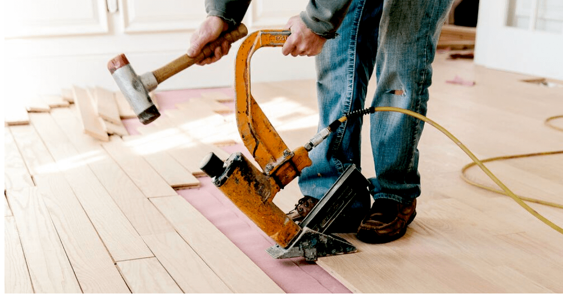 contractor working on flooring inside home