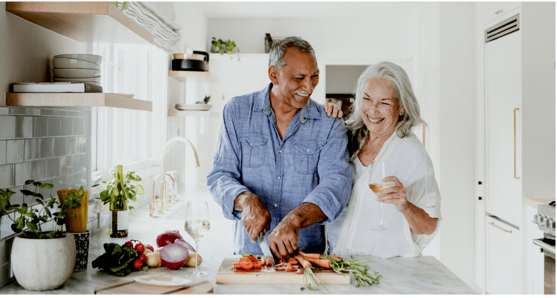 elderly couple cooking in kitchen