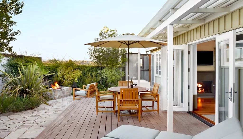 wood deck and stone patio in backyard