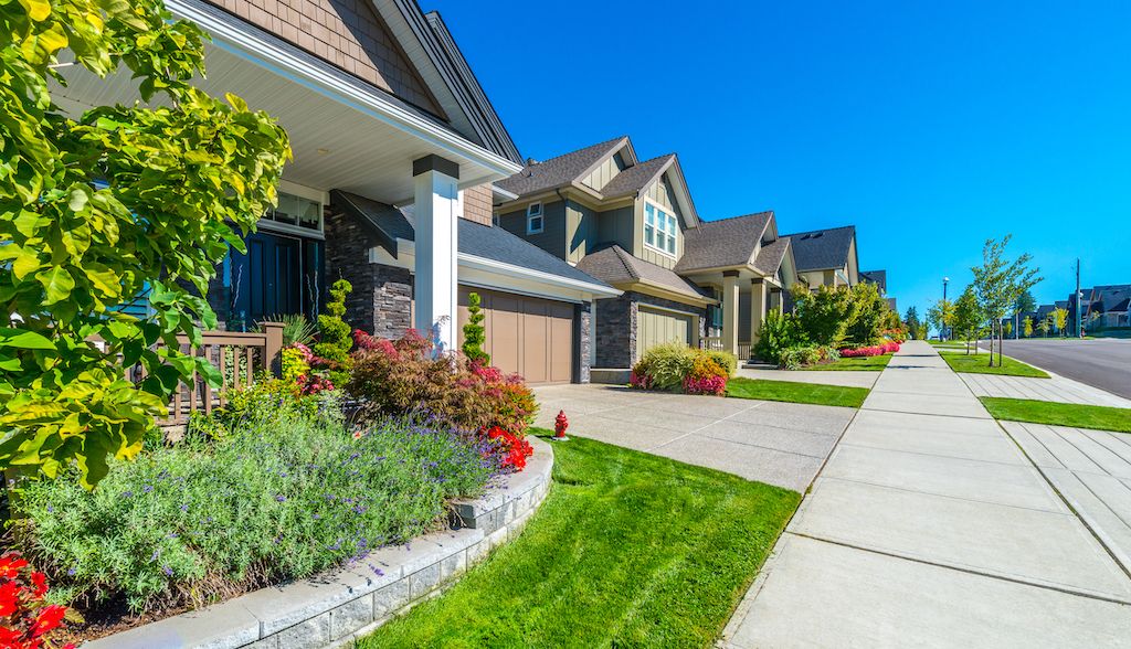 street of neighborhood houses with front yards