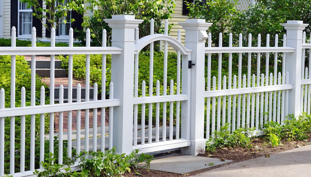 white fence and gate around house