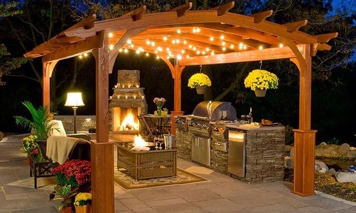 string lights on pergola above fire pit
