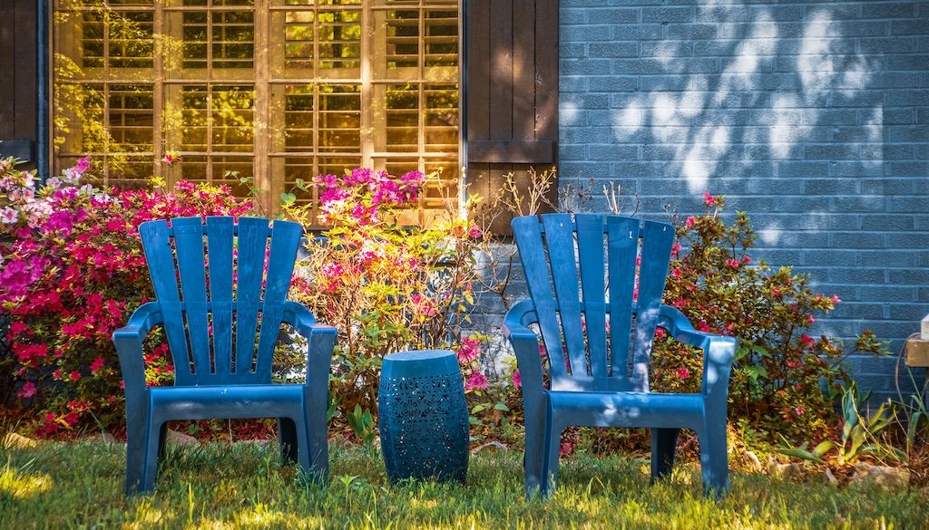 two blue chairs in front yard for sitting
