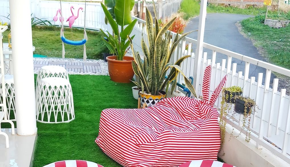 seating and potted plants on turf in side yard of house