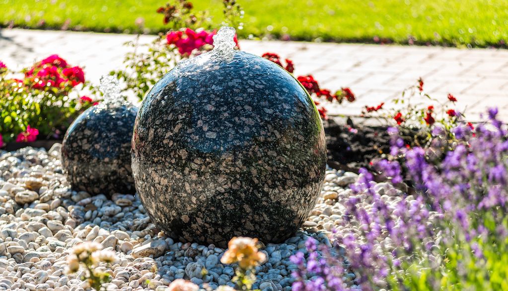 small sphere water fountain in front yard